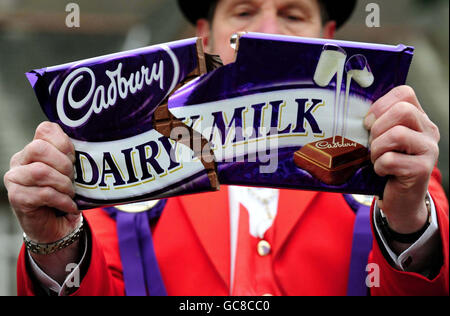 A lone protestor breaks a Cadbury chocolate bar outside the Bournville factory, Birmingham, after it was announced that Cadbury had backed a higher 11.5 billion recommended takeover offer from its US suitor Kraft Foods. Stock Photo