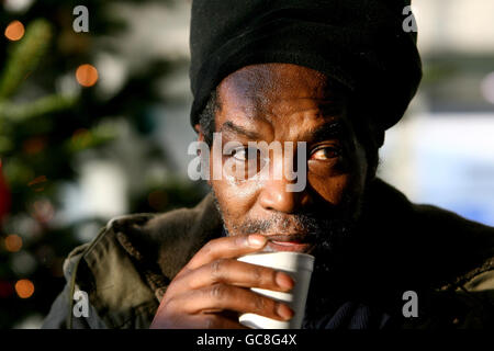 Roy, who is homeless, takes a sip of tea at one of nine temporary centres across London set up by the homeless charity Crisis, at Ivax Quays, Royal Docks, in east London. Stock Photo