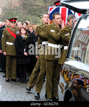 Sian Goodenough watches as the coffin of her fiance Lance Corporal Adam Drane, 23, of 1st Battalion, The Royal Anglian Regiment arrives at St Mary's Church, Bury St Edmunds. Stock Photo