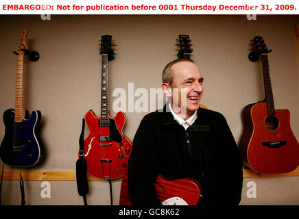 Status Quo's Francis Rossi at his home in south London after it was revealed that he and Rick Parfitt have been awarded OBEs in the New Year Honours List for their hugely successful musical career, including over 118 million record sales worldwide and a record-breaking 64 British hit singles. Stock Photo