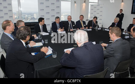 Prime Minister Gordon Brown, (centre left), Energy Secretary Ed Miliband (left of Brown) and Business Secretary Lord Mandelson (third right of Brown) talk to representatives of major energy companies at Millbank Tower in central London, about the launch a new initiative to build off-shore wind farms. Stock Photo