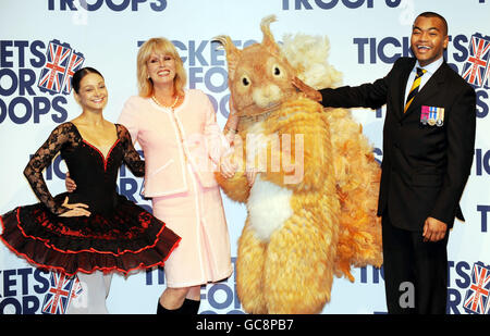 Actress Joanna Lumley accompanies Roberta Marquez, Principal with the Royal Ballet, a character dancer from the tales of Beatrix Potter, Squirrel Nutkin and Lance Corporal Johnson Beharry VC at the Royal Opera House in London to announce a special Valentine's Day family performance of opera La Boheme, and ballet The tales of Beatrix Potter at the opera house which has donated the entire auditorium to the Tickets for Troops charity. Stock Photo