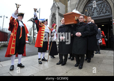 Town criers form a guard of honour to ring out at the funeral mass of colleague Peter Moore, at St George's Cathedral, Southwark. Stock Photo