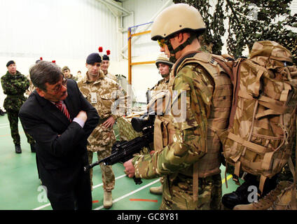 Defence Secretary Bob Ainsworth meets soldier Robert Clark (right) from the Second Fusilier guards at their barracks in Hounslow. Stock Photo