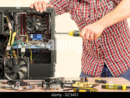 Technician repair assembles computer. Toned image. Stock Photo