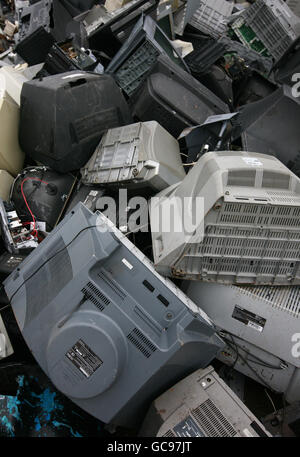 Old television sets and computer monitors are piled high at recycling company SWEEEP in Sittingbourne, Kent, as the demand for flat panel screens sees the company currently recycling 4,000 of the old or broken screens every 24 hours. Stock Photo