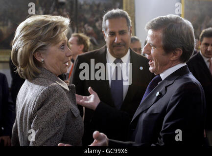 U.S. Secretary of State Hillary Clinton (left) speaks with France's Foreign Minister Bernard Kouchner (right) before the start of the opening session of the Afghanistan Conference in London. Stock Photo