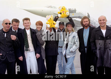 MEMBERS OF POP GROUPS MADNESS, BEE GEES AND RIGHT SAID FRED WITH SINGERS KIKI DEE & GABRIELLE [HOLDING BEAR] BEFORE TAKE OFF AT HEATHROW FOR THE FIRST SUPERSONIC LIVE RADIO BROADCAST FROM CONCORDE TO RAISE FUNDS FOR THE BBC'S CHILDREN IN NEED APPEAL. Stock Photo
