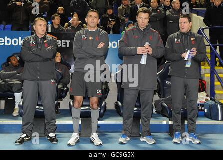 (left-right) Bolton Wanderers' Assistant Manager Sandy Stewart, Manager Owen Coyle, First Team Coach Steve Davis and Goalkeeping Coach Phil Hughes on the touchline Stock Photo