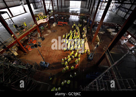 Construction workers gather inside the shell of Weston-super-Mare Grand Pier as owner Kerry Michael gives a speech after a topping out ceremony on the North Eastern tower of the pier as work is on schedule for completion and the re-opening in Summer 2010 after it was destroyed by fire in July 2008. Stock Photo