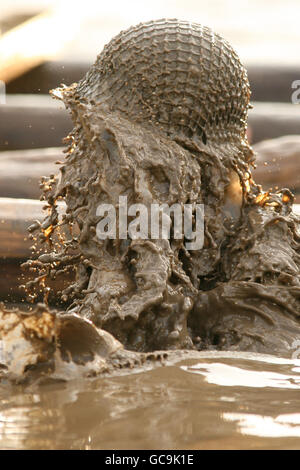 Tough Guy 2010 - Year Of The Original Heroes - Perton. A competitor emerges from the water tunnel during tough guy Stock Photo