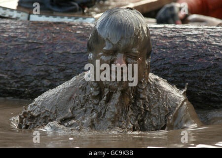 Tough Guy 2010 - Year Of The Original Heroes - Perton. A competitor emerges from the water tunnel during tough guy Stock Photo