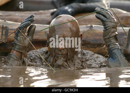 Tough Guy 2010 - Year Of The Original Heroes - Perton. A competitor emerges from the water tunnel during tough guy Stock Photo