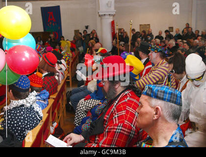 Clowns during the annual remembrance service for the celebrated clown Joseph Grimaldi, in the Holy Trinity church, Dalston, London. Stock Photo