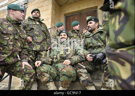 Royal Marine Commandos from 40 Commando, based in Taunton, chat and relax with soldiers from the Afghan National Army (ANA) as they closely exercise together on Salisbury Plain duringa pre-deployment training exercise for 4th Mechanized Brigade as they prepare for Afghanistan. Using serving ANA soldiers during pre-deployment exercises is beneficial for the British forces to inject realism, help bridge cultural gaps and enhance the experience they will have working with the ANA during combat. Stock Photo