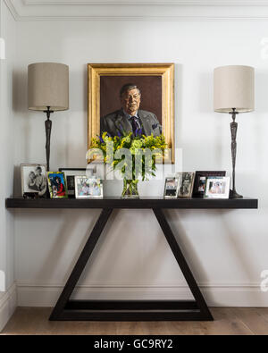 Family photos on a console table by John Chichester