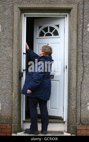 A woman from Lothian and Borders Police Scientific Support Unit (name not known) checks the front door of Susan Boyle's home in Blackburn, West Lothian. The singer returned home to find an intruder inside her house after she returned from London on Tuesday night where she had been helping to record the Helping Haiti single. Stock Photo