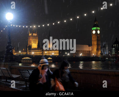 The Houses of Parliament are seen from Albert Embankment as light snow falls in London. Stock Photo