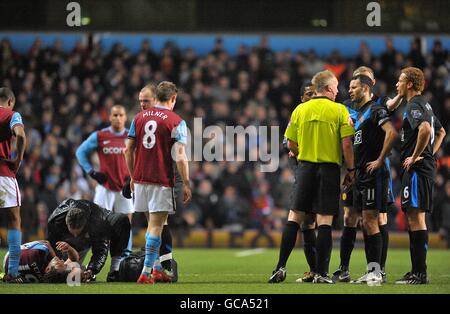 Manchester United Captain Ryan Giggs (2nd right) speaks to referee Peter Walton after team mate Luis Nani (not pictured) is shown a red card for his challenge on Aston Villa's Stiliyan Petrov (left) Stock Photo