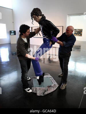 Michael Jackson sculpture entitled 'Dangerous' is placed in position by staff, Kevin Storrar and Rob Allen (right) at the New Art Gallery, Walsall. Stock Photo