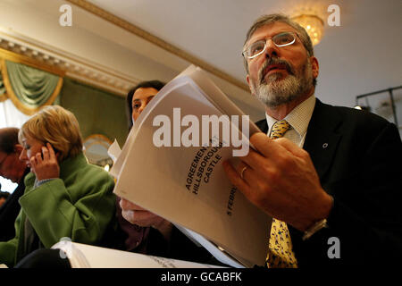 Sinn Fein's Gerry Adams with a copy of the agreement after a deal was announced about Northern Ireland's power-sharing government at the press conference in Hillsborough. Stock Photo