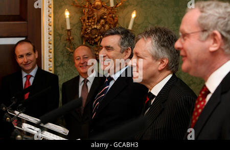 Irish Foreign Affairs Minster Michael Martin (far left) and Secretary of State for Northern Ireland (second left) looks on as Prime Minister Gordon Brown (centre left), DUP leader Peter Robinson (centre right) and Sinn Fein's Martin McGuinness (right) speak during a press conference after a deal was announced about Northern Ireland's power-sharing government. Stock Photo
