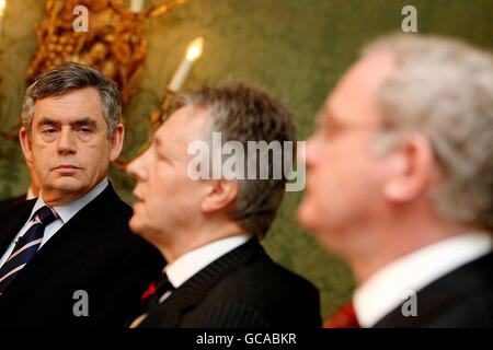 Prime Minister Gordon Brown (left), DUP leader Peter Robinson (centre) and Sinn Fein's Martin McGuinness (right) during a press conference after a deal was announced about Northern Ireland's power-sharing government. Stock Photo