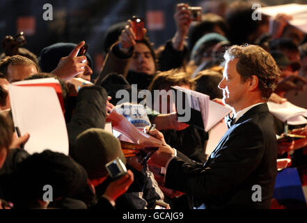 Colin Firth signs autographs as he arrives at the Orange British Academy Film Awards, at The Royal Opera House, London. Stock Photo