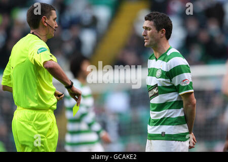 Soccer - Clydesdale Bank Premier League - Celtic v Dundee United - Celtic Park. Robbie Keane, Celtic booked by Craig Thomson, Referee Stock Photo