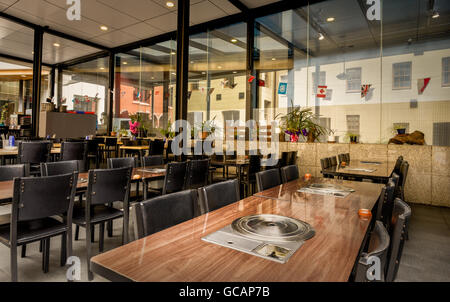 International restaurant in the building with walls of glass and large tables for many people Stock Photo