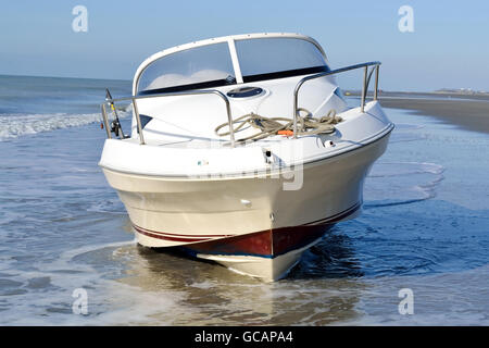 Motor boat aground on the beach of Fort-Mahon in the Somme department, France Stock Photo