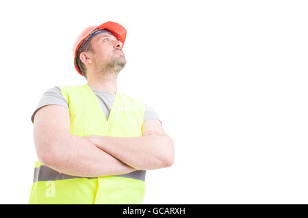 Low angle portrait of constructor standing with arms crossed and looking up isolated on white with advertising area Stock Photo
