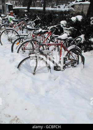A row of bicycles partly hidden by a covering of snow in the Norwegian capital, Oslo. Stock Photo