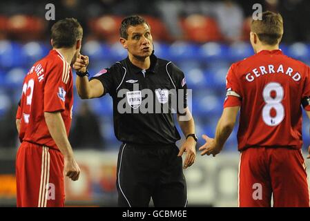 Soccer - Barclays Premier League - Wigan Athletic - Liverpool - DW Stadium. Liverpool's Steven Gerrard (right) and Jamie Carragher (left) argue with referee Andre Marriner Stock Photo