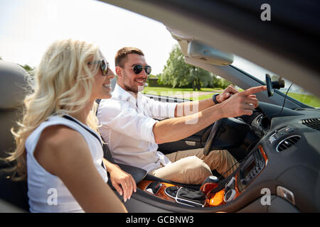 happy couple using gps navigation system in car Stock Photo