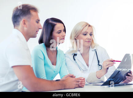 doctor with patients looking at x-ray Stock Photo