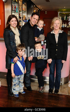 Former England rugby player Kyran Bracken arrives with his family at the Planet Hollywood Mothers Day Brunch in London. Back row, left to right, Victoria, Kyran, Lochlan and mum Jane Bracken. Front row left to right, Jack and Charlie Bracken. Stock Photo