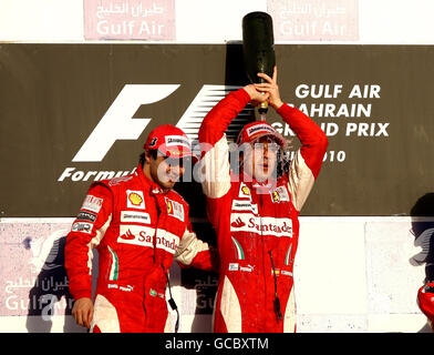 Ferrari driver Fernando Alonso celebrates his victory with second placed Felipe Massa (left) during the Gulf Air Bahrain Grand Prix at the Bahrain International Circuit in Sakhir, Bahrain. Stock Photo