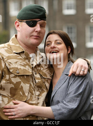 Rifleman Paul Jacobs, of The Rifles, who was awarded a George Medal in the Operational Awards List, and his fiancee Louise Smith, 24, at a ceremony at the Honourable Artillery Company, in central London. Stock Photo