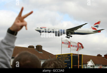 ALTERNATE CROP. Striking British Airways cabin crew gesture at a landing British Airways flight, at a rally in Bedfont, Middlesex, near Heathrow Airport. Stock Photo