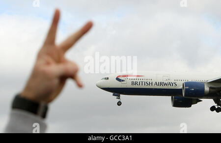 Striking British Airways cabin crew gesture at a landing British Airways flight, at a rally in Bedfont, Middlesex, near Heathrow Airport. Stock Photo