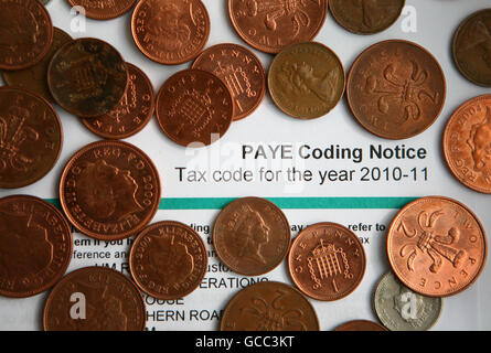 A PAYE Tax Code Notice surrounded by 2p and 1p coins. Stock Photo