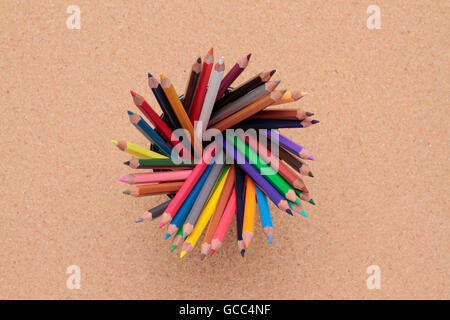 view from above of some colored pencils on cork background Stock Photo