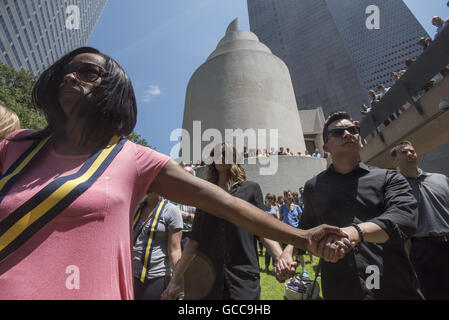 Dallas, Texas, USA. 8th July, 2016. DELEAH CARO, left, and VINCENT HOLLAND hold hands during a prayer vigil for the victims of Police shootings and their families held at Thanksgiving Square. A Sniper killed four Dallas police officers and one Dallas Area Rapid Transit (DART) officer during a protest by Black Lives Matter. Credit:  ZUMA Press, Inc./Alamy Live News Stock Photo