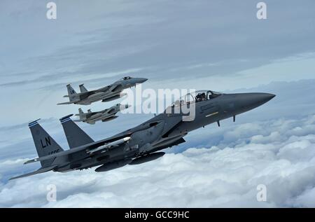 U.S. Air Force F-15C Eagles fighter aircraft assigned to the 493rd Fighter Squadron, and an F-15E Strike Eagle assigned to the 492nd Fighter Squadron during a flight July 7, 2016 over Gloucestershire, England. The fighters are heading to the Royal International Air Tattoo airshow held at RAF Fairford. Stock Photo