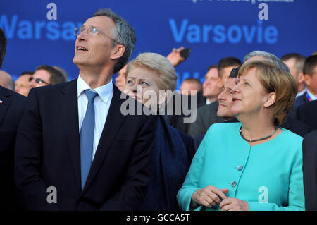 Warsaw, NATO summit in Warsaw. 8th July, 2016. NATO Secretary General Jens Stoltenberg(L, front) and German Chancellor Angela Merkel(R, front) watch the air show during the opening ceremony of the NATO summit in Warsaw, Poland on July 8, 2016. The NATO summit kicked off here Friday afternoon, with Polish President Andrzej Duda and NATO Secretary General Jens Stoltenberg officially greeting participants at the National Stadium PGE. © Shi Zhongyu/Xinhua/Alamy Live News Stock Photo
