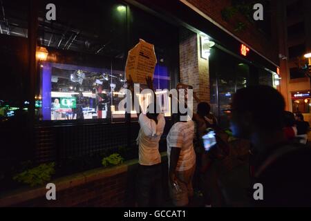 Philadelphia, Pennsylvania, USA. 8th July, 2016. From outside the studio on Market Street, in Philadelphia, Pennsylvania, protesters from a July 9th, 2016 Black Lives Matter march try to distract WTXF-TV anchors during a live broadcast. Credit:  Bastiaan Slabbers/ZUMA Wire/Alamy Live News Stock Photo