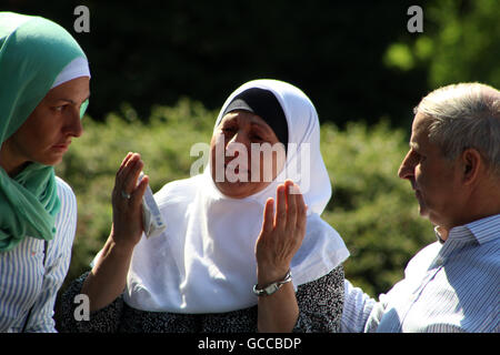 Visoko, Bosnia and Herzegovina. 9th July, 2016. SABAHETA KANDÅ½ETOVIC is seen crying and praying next to the truck that contains coffins with the remains of victims from the 1995 Srebrenica massacre. Credit:  Armin Durgut/ZUMA Wire/Alamy Live News Stock Photo