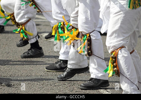 Ewell, Epsom, Surrey, England, UK. 9th July 2016. The Spring Grove Kingston Morris Men performing at the Ewell Village Fair, Surrey, on the Time Well Spent Day of Dance. They were joined by dance sides from Carshalton and Ewell St Mary’s Morris Men to make one of the largest displays of Morris Men. They started at the Green Man pub for 30 minutes of dancing before parading along the High Street to the Lock Up for a drinking challenge, then off for more dancing. Credit:  Julia Gavin UK/Alamy Live News Stock Photo