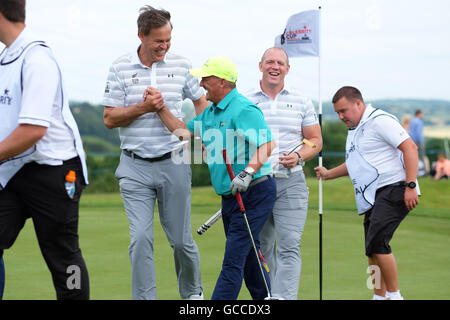 Celtic Manor, Newport, Wales - Saturday 9th July 2016 - The Celebrity Cup golf competition entrepreneur Peter Jones congratulates comedian Brendan O'Carroll with Mike Tindall behind. Photograph Steven May / Alamy Live News Stock Photo